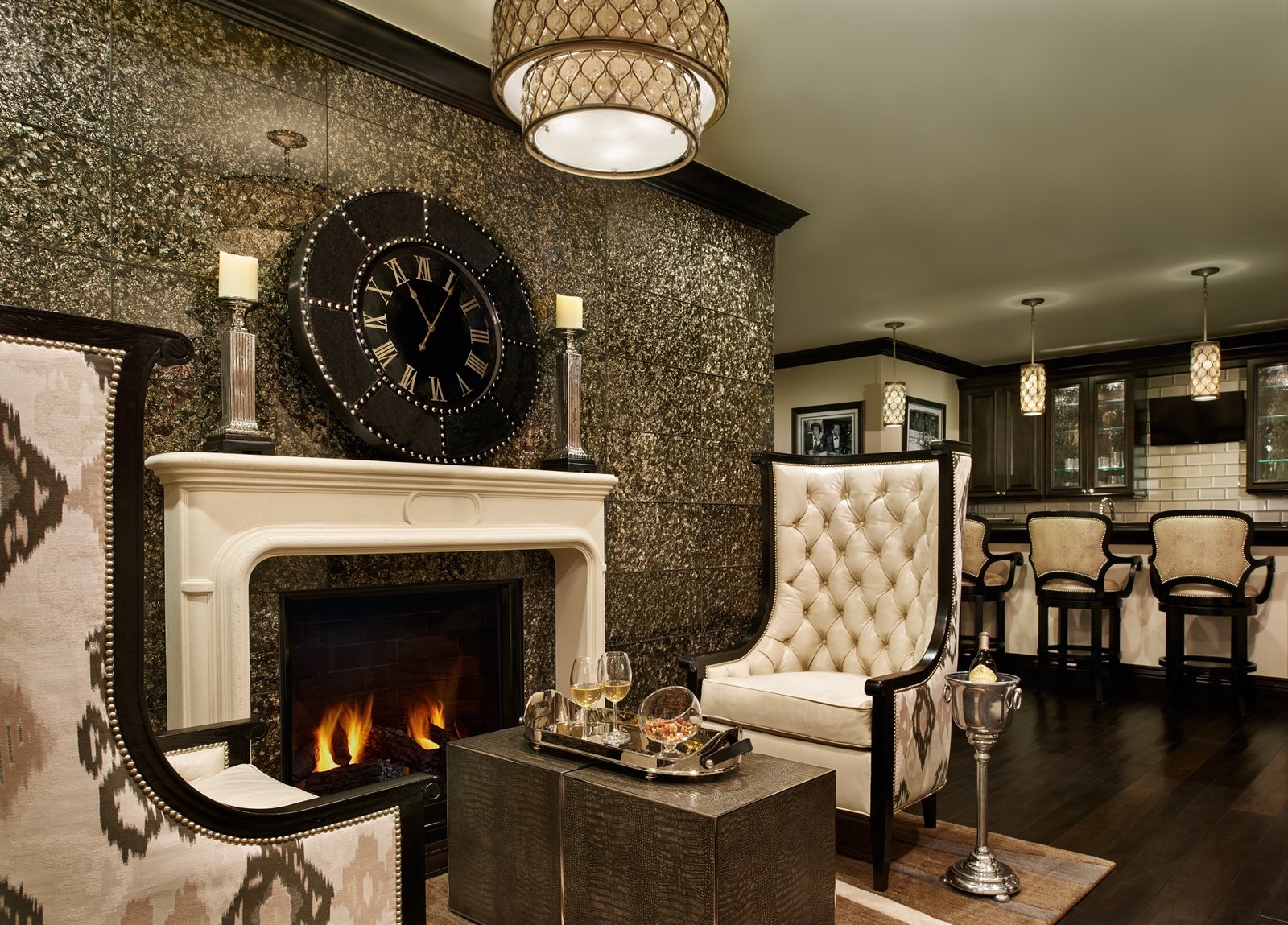 Elegant sitting room with tufted chairs and stone fireplace, designed by Carla's A Classic Design