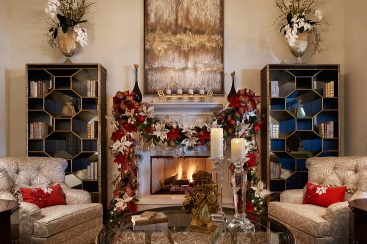 Holiday fireplace vignette with poinsettia garland, styled by Carla's A Classic Design